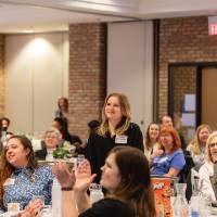 many people at luncheon seated and standing